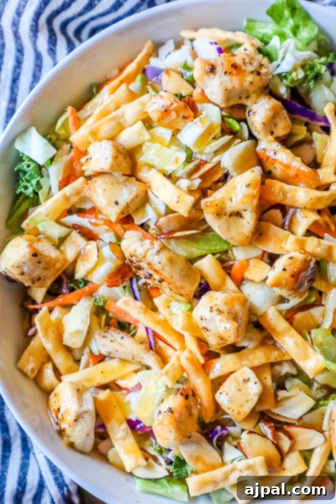 A large bowl of delicious Chinese chicken noodle salad, featuring tender chicken and crisp vegetables.