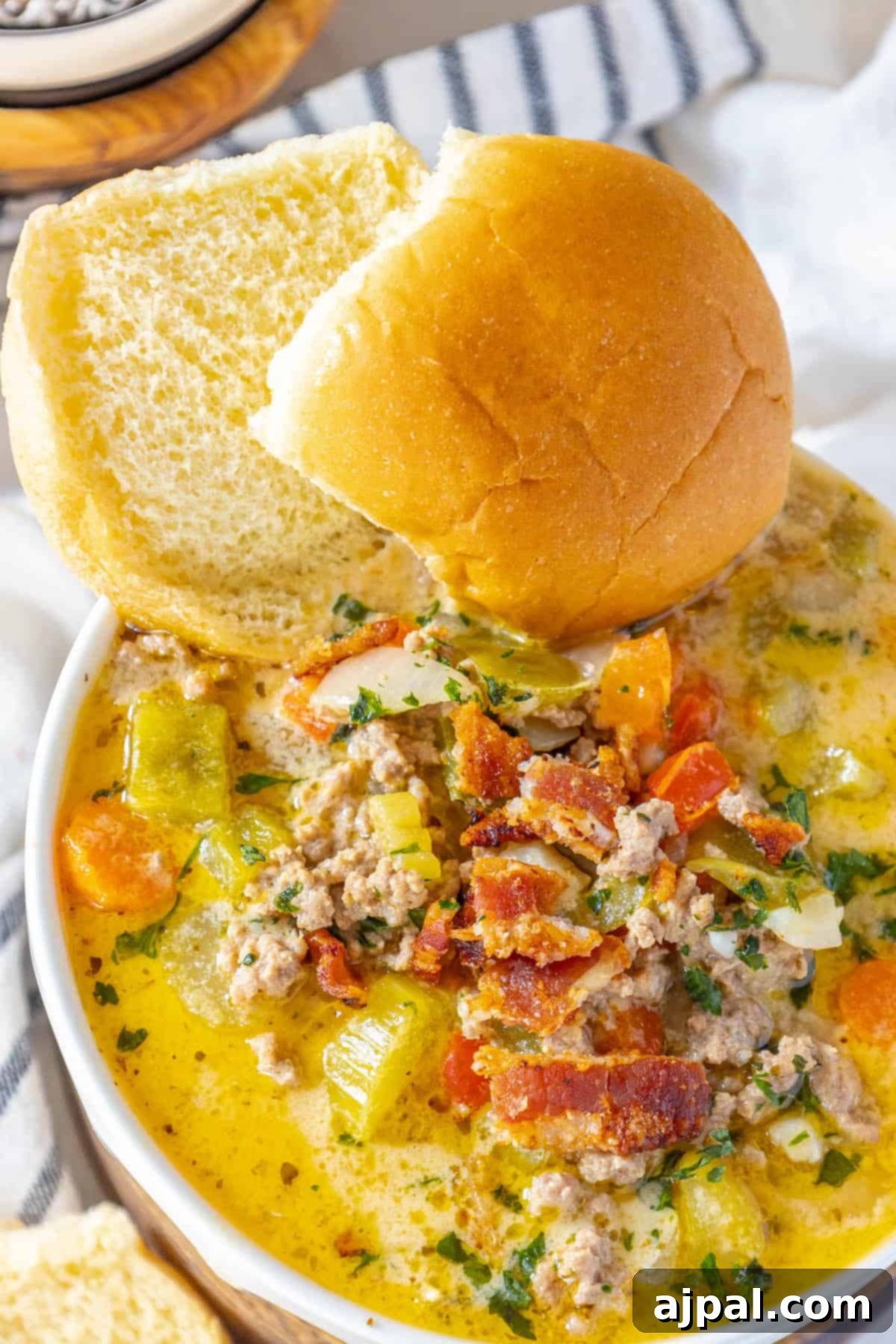 A bowl of Keto Cheeseburger Soup topped with bread.