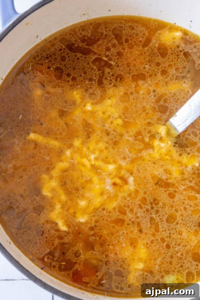 Easy One Pot Cheeseburger Soup Recipe with a spoon in it.