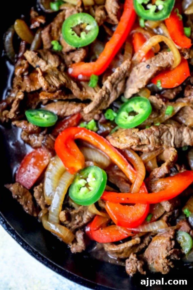 Ultimate One-Pan Steak Fajitas 5 A vibrant one-pot skillet dish featuring tender beef strips, colorful peppers, and onions