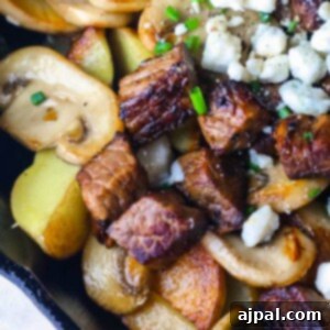 Savory Blue Cheese Steak and Potato Skillet 9 A skillet filled with steak, potatoes, and feta cheese.