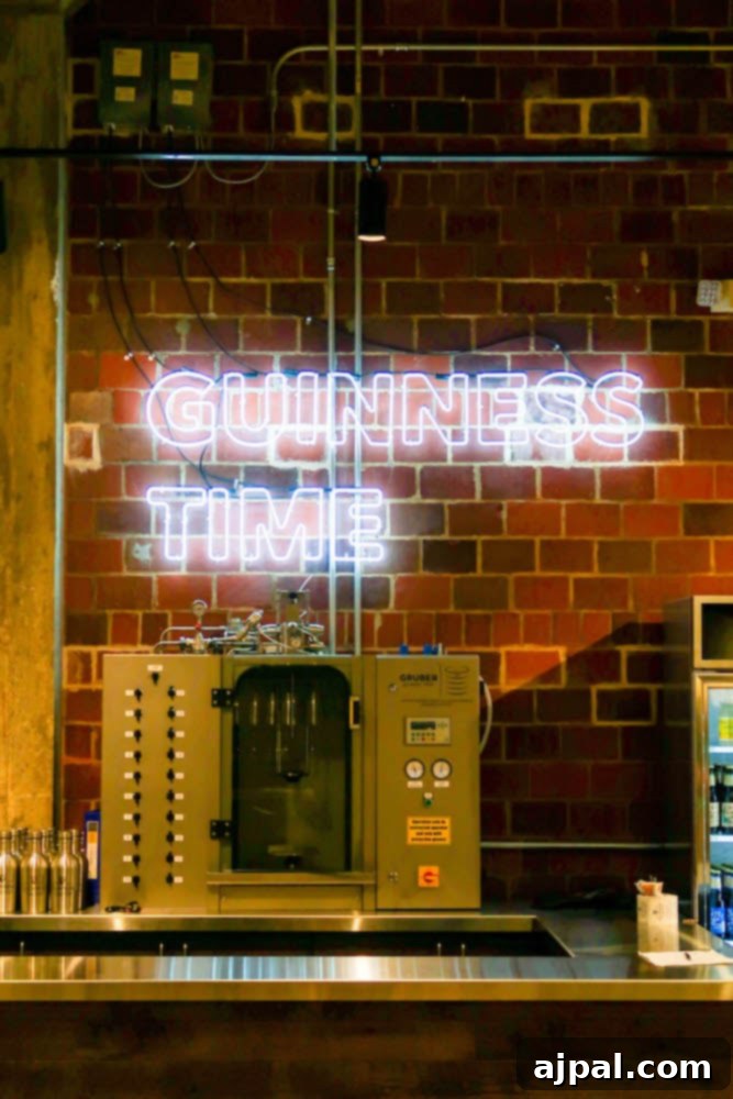 A vibrant neon sign at a brewery glows with the words 'Guinness Time,' setting the perfect mood for enjoying craft beers and delicious snacks.