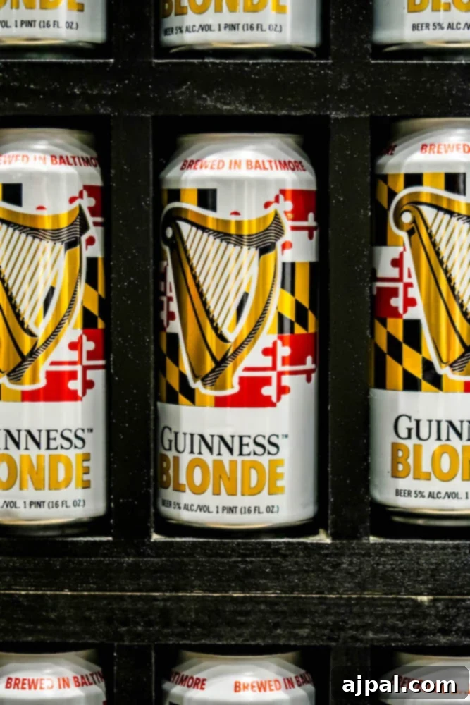 A meticulously arranged display of Guinness Blonde cans showcases the brewery's diverse offerings, alongside a delectable sweet and spicy snack mix.