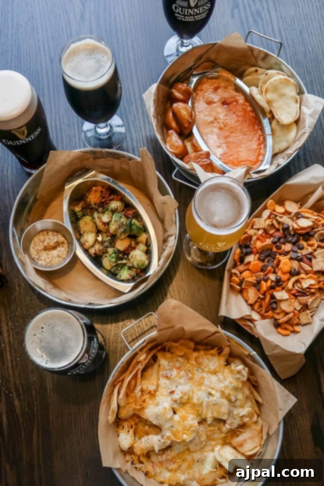 A rustic wooden table laden with an enticing spread of appetizers, including the signature Sweet and Spicy Guinness Snack Mix, at the lively Guinness Brewery in Maryland.