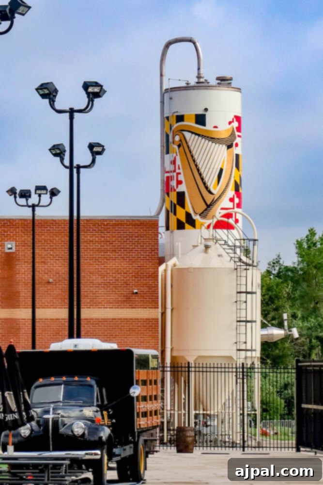 The impressive facade of the Guinness Brewery in Maryland, featuring a distinctive truck adorned with a harp decoration, highlighting the brand's heritage.