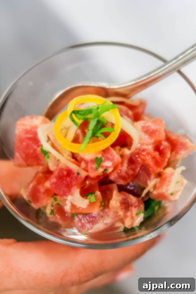 A person enjoys a fresh bowl of tuna salad, with easy apple turnovers nearby, highlighting the diverse and delicious meal options available on a Royal Princess Cruise.