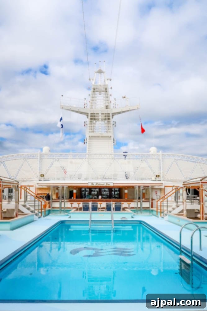 A stunning cruise ship with a vibrant swimming pool deck, inviting passengers to relax, swim, and enjoy the sun while at sea with Princess Cruises.
