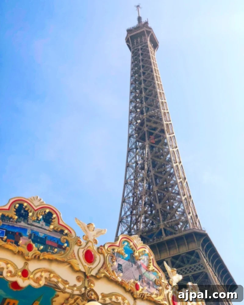 The iconic Eiffel Tower stands majestically beside a charming carousel in Paris, a highlight of a Princess Cruises shore excursion offering a blend of classic sightseeing and romantic allure.