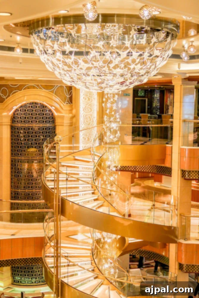 A grand spiral staircase in the elegant, sunlit lobby of a Princess cruise ship, symbolizing the luxury and seamless ease of travel and onboard experiences.