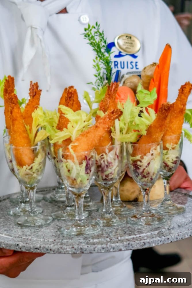 A skilled chef proudly holds a tray filled with various delightful pastries, including apple hand pies and puff pastry turnovers, showcasing Princess Cruises' commitment to culinary excellence.