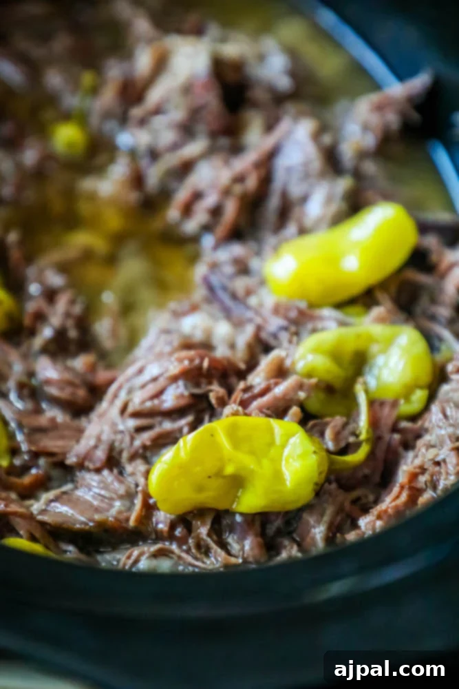Southern Slow Cooker Pot Roast 5 A savory crock pot dish featuring tender beef and peppers, a delicious twist on the classic Mississippi Roast recipe, ready to be enjoyed.