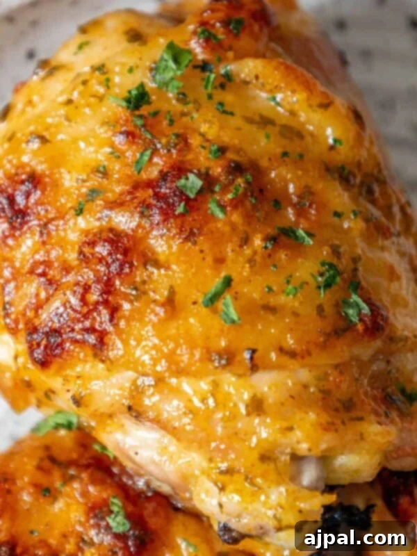 A plate of baked ranch chicken thighs, garnished with parsley.