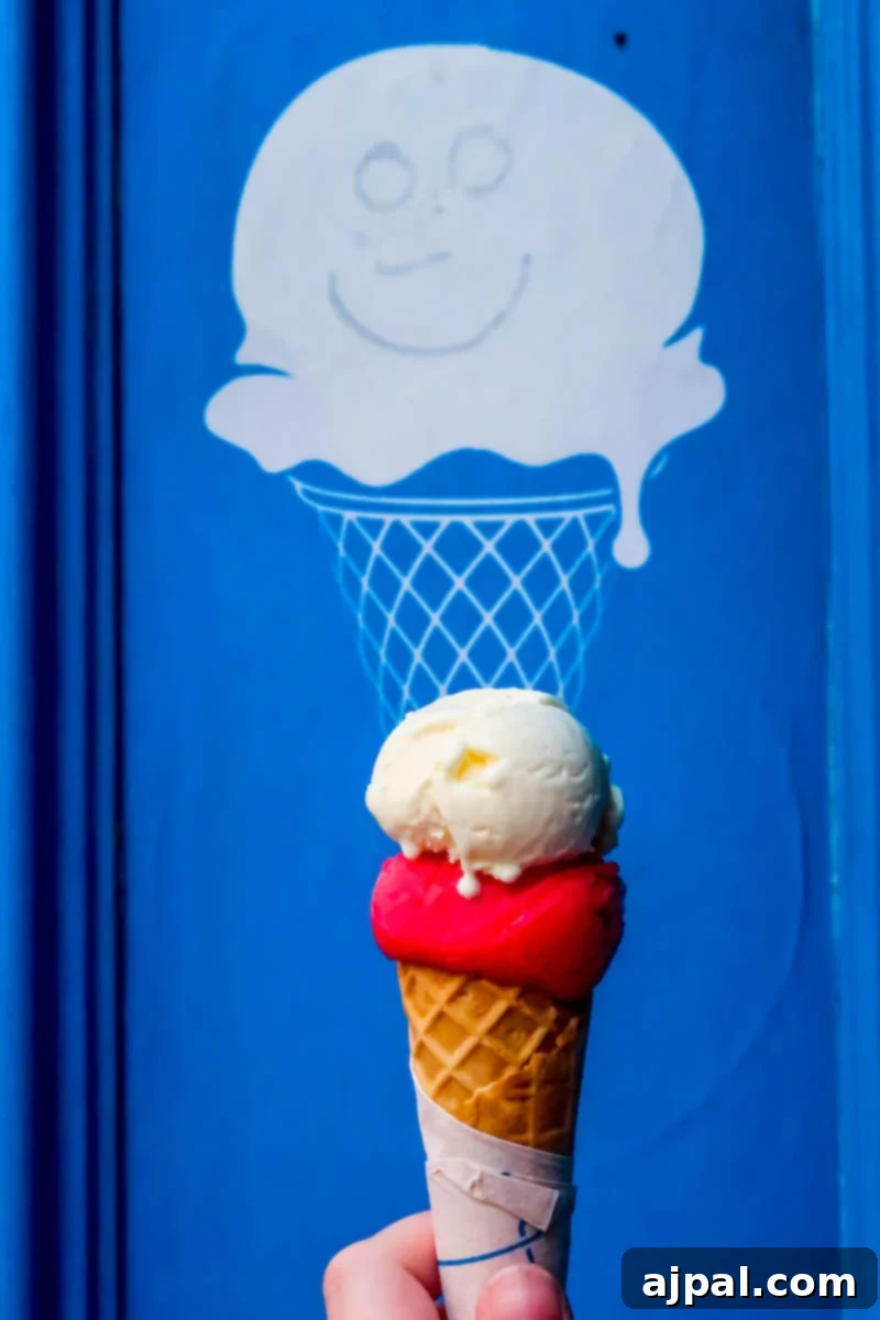 Hand holding a delicious ice cream cone in front of a blue door in Dublin