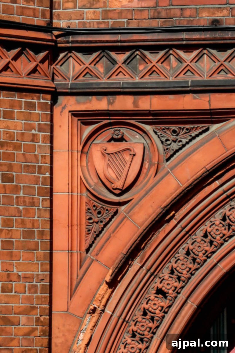 Elegant harp detail on a historic red brick building in Dublin