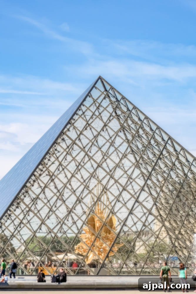 Book a British Isles Cruise: Your Adventure Awaits 2 The stunning glass pyramid entrance to the Louvre Museum in Paris, France.
