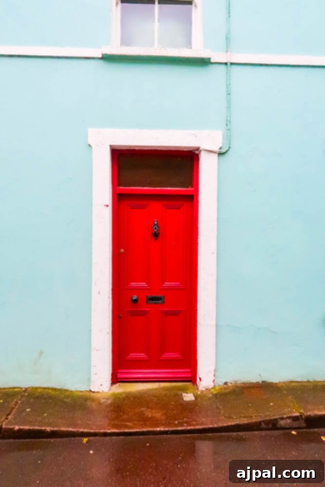 Book a British Isles Cruise: Your Adventure Awaits 11 A vibrant red door contrasts beautifully with a blue building in Cork, Ireland.