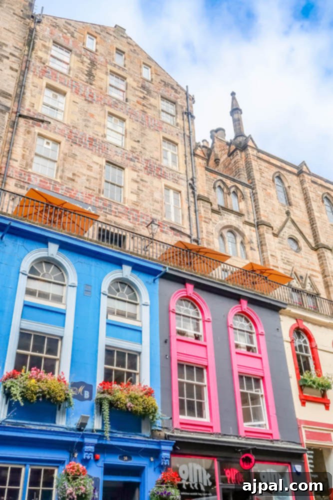 Book a British Isles Cruise: Your Adventure Awaits 14 A cobblestone street in historic Edinburgh, with ancient buildings and a moody sky.