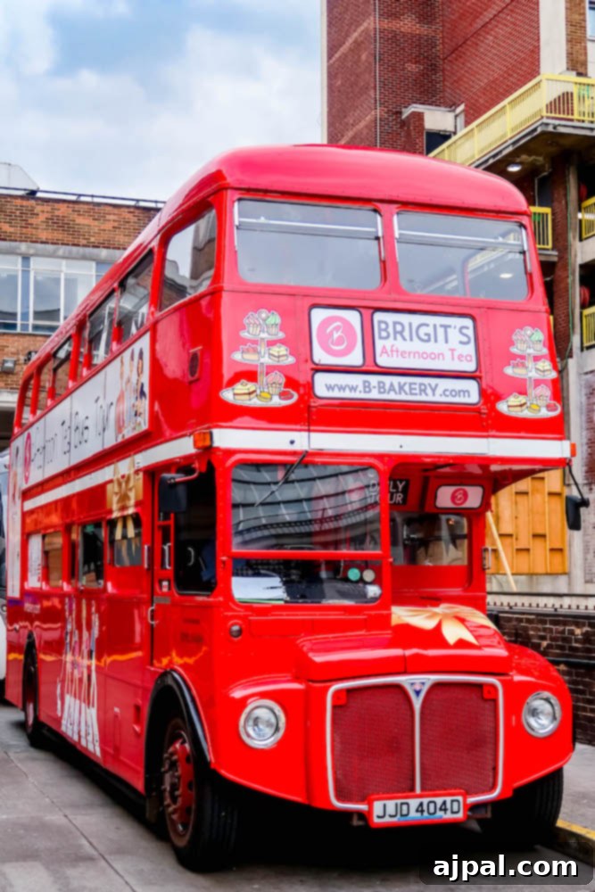 Book a British Isles Cruise: Your Adventure Awaits 8 A classic red double-decker bus, adapted for a delightful tea experience, drives through London streets.