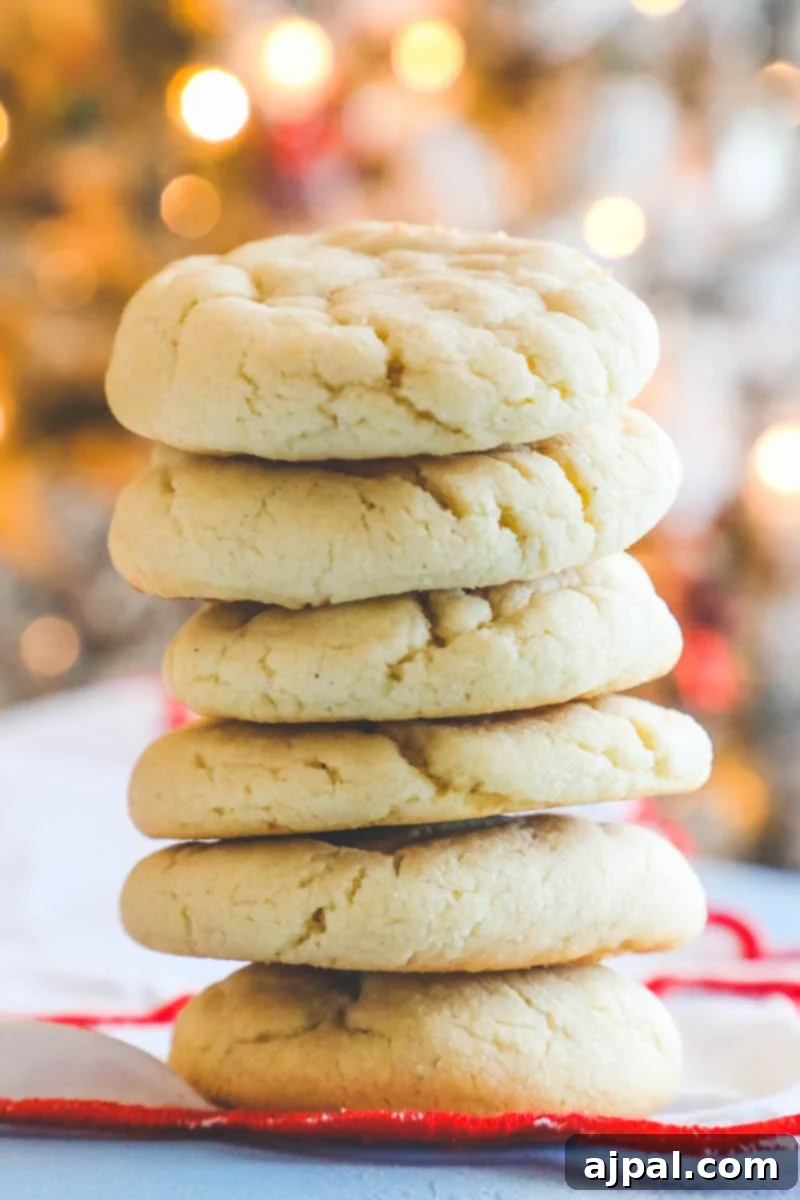 Unforgettable Chewy Sugar Cookies Easy Recipe 4 A close-up of soft, chewy sugar cookies with a hint of holiday decoration in the background.