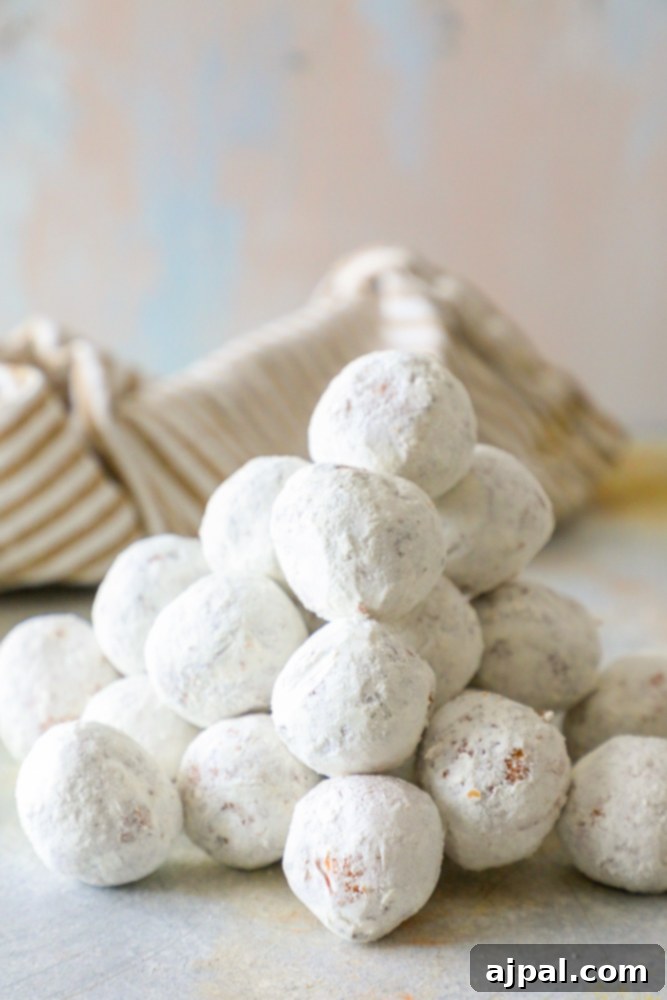 Effortless Powdered Doughnut Delights 3 pile of powdered sugar donut holes