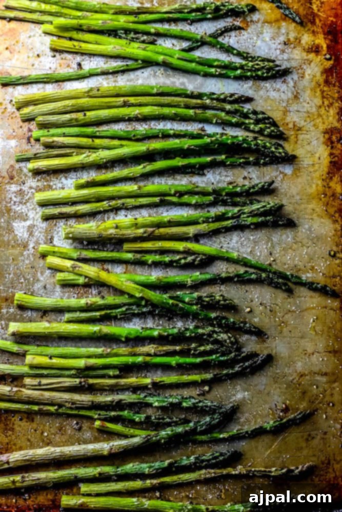 Crispy Roasted Asparagus 3 Close-up of golden-brown roasted asparagus spears on a sheet pan