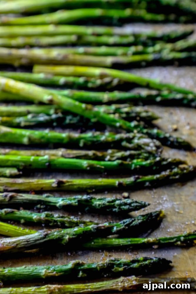 Crispy Roasted Asparagus 7 A generously seasoned batch of oven roasted asparagus on a baking sheet