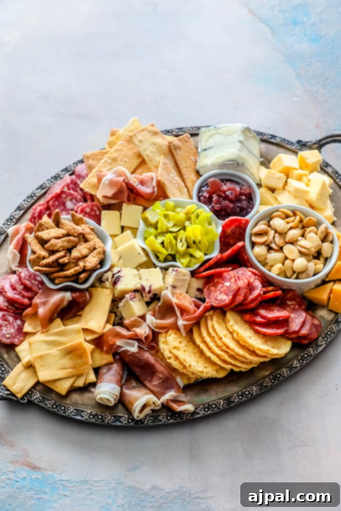 Crafting the Perfect Cheese Board 6 An elaborate cheese plate featuring an assortment of sliced cheeses, cured meats, crunchy nuts, and various crackers, artfully arranged on a rustic tray.