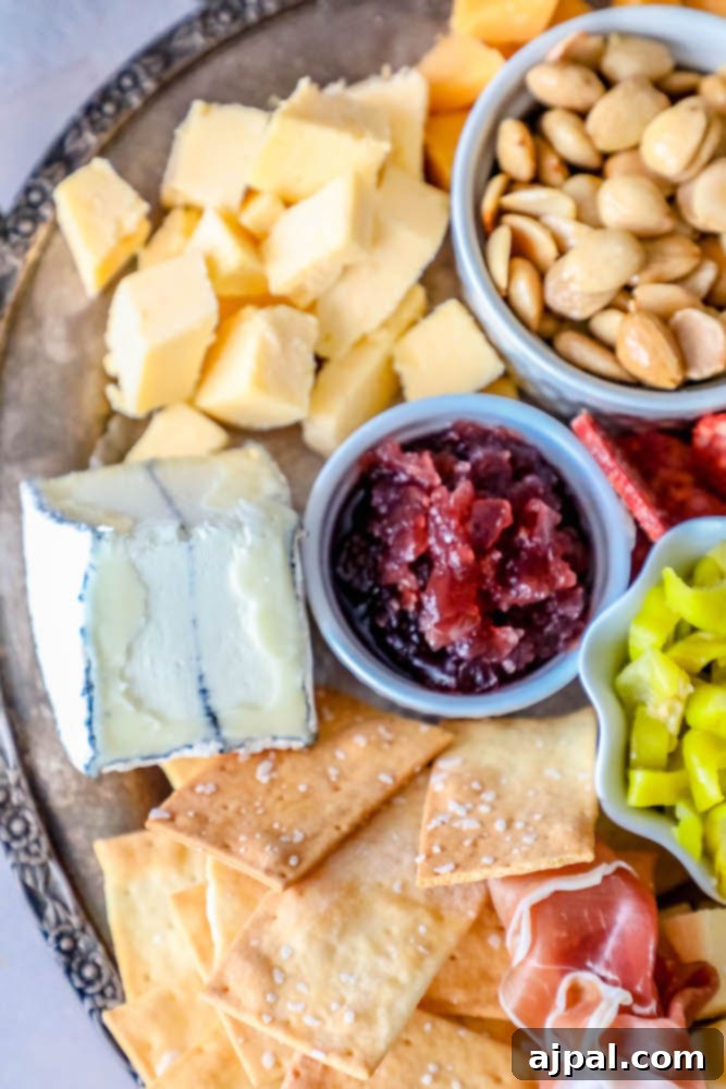 Crafting the Perfect Cheese Board 8 An opulent platter featuring a diverse selection of cheeses, various jams and confits in small bowls, an assortment of crackers, and delicately sliced cured meats.