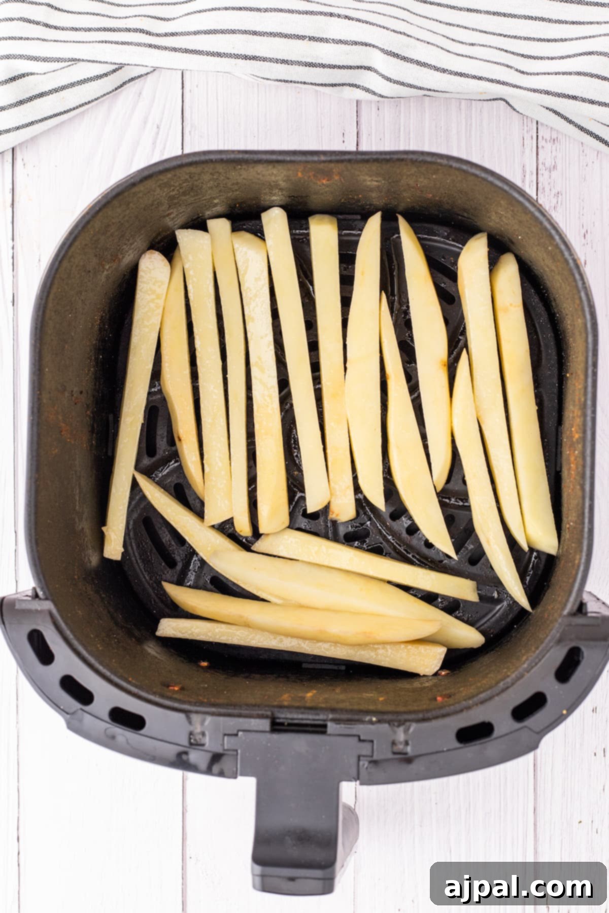 french fries in an air fryer basket