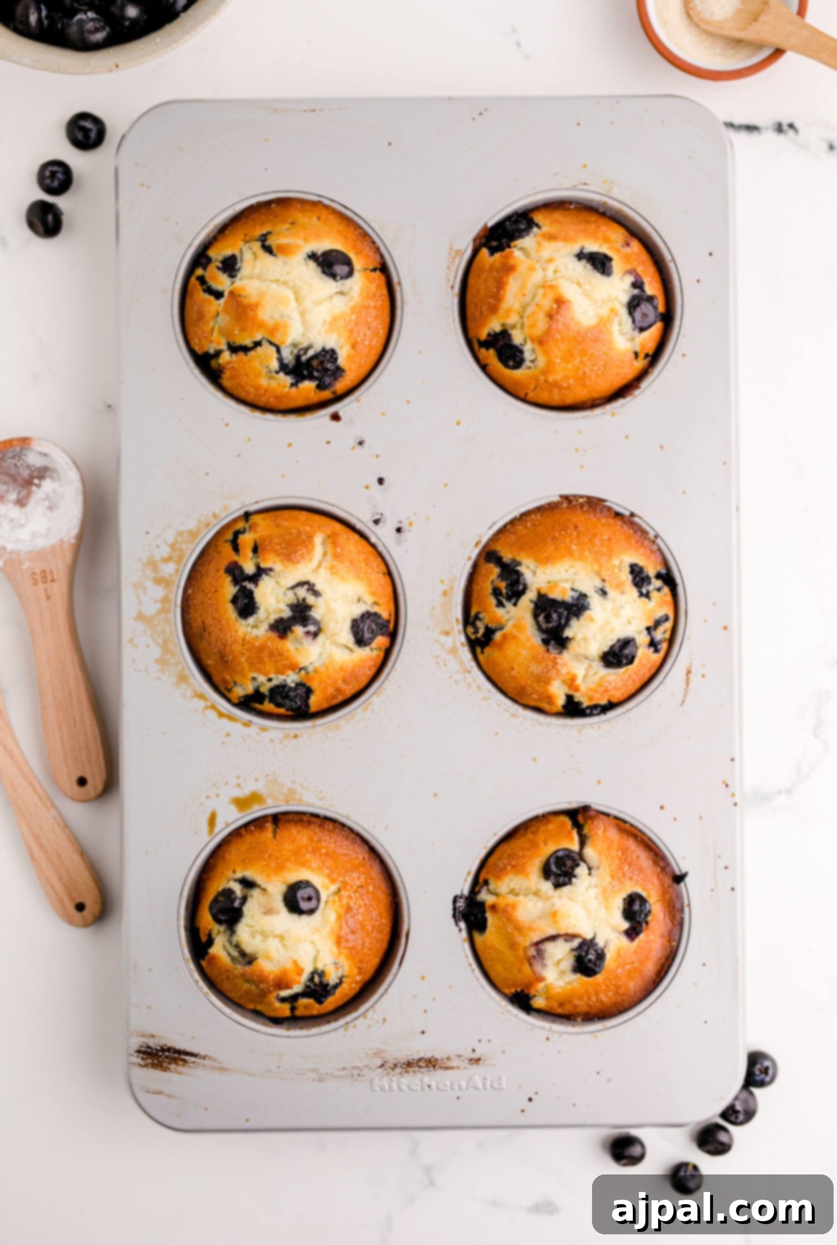 Jumbo Blueberry Muffins in a muffin tin.