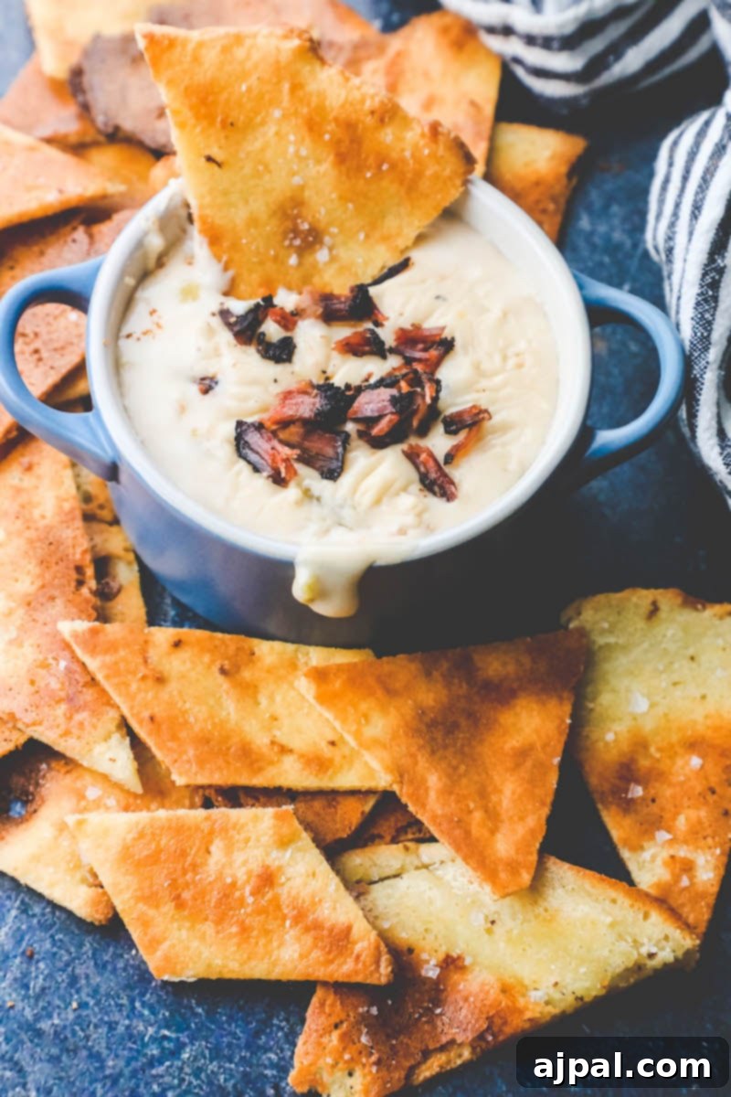Quick Keto Tortilla Crisps 7 Picture of keto tortilla chips on a plate with dip, demonstrating their use in a keto nacho setup.