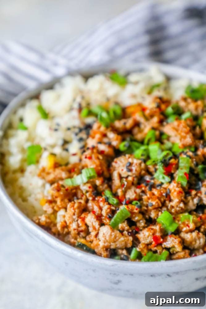 A vibrant bowl featuring keto teriyaki ground turkey, fluffy cauliflower rice, and fresh green onions, ready to be enjoyed.