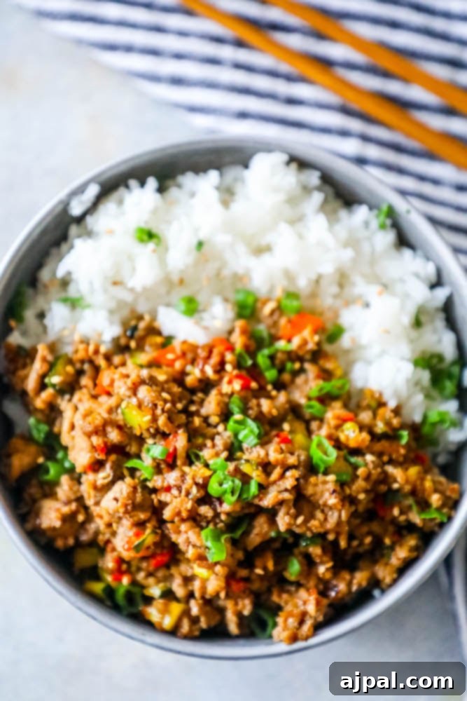 Weeknight Mongolian Turkey Rice Bowls 7 A beautifully arranged bowl of Mongolian Ground Turkey and Rice, garnished with fresh toppings, ready to be served.