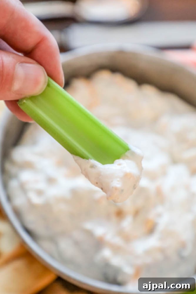 Quick Keto Bacon Cheddar Ranch Dip 4 A spoon scooping creamy Keto Bacon Cheddar Ranch Dip from a bowl, highlighting its rich texture