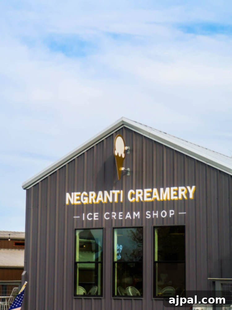 A charming building with a sign for Negranti Creamery Ice Cream Shop, a sweet stop in Tin City, Paso Robles, known for its diverse activities and accommodations.