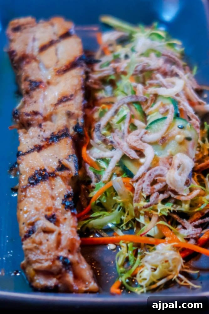 A plate with a grilled piece of meat and vegetables, enjoyed in Santa Monica.