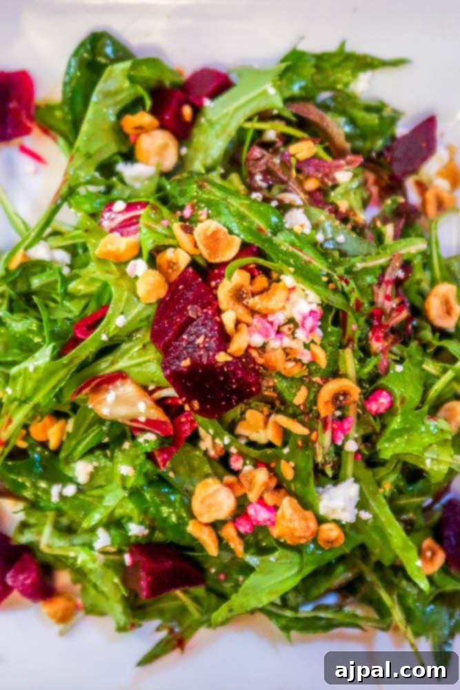 Visit Oxnard and enjoy a salad with beets and nuts on a white plate.