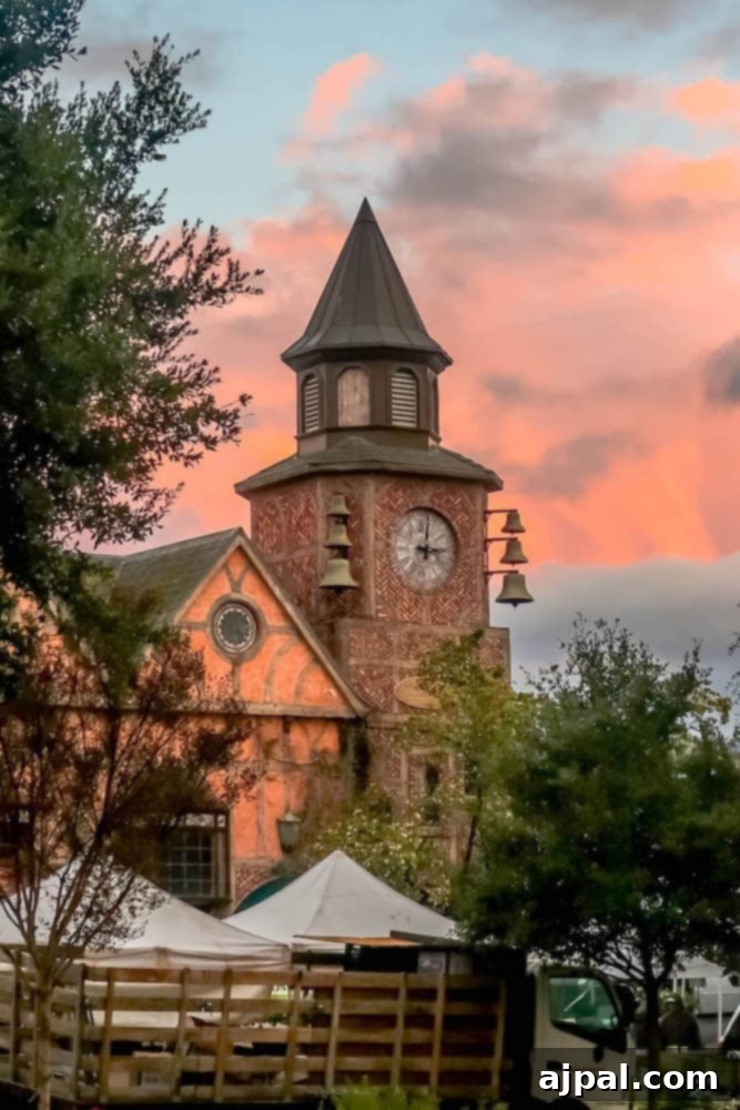A clock tower in front of a building offering a perfect day in the Santa Ynez Valley at sunset.