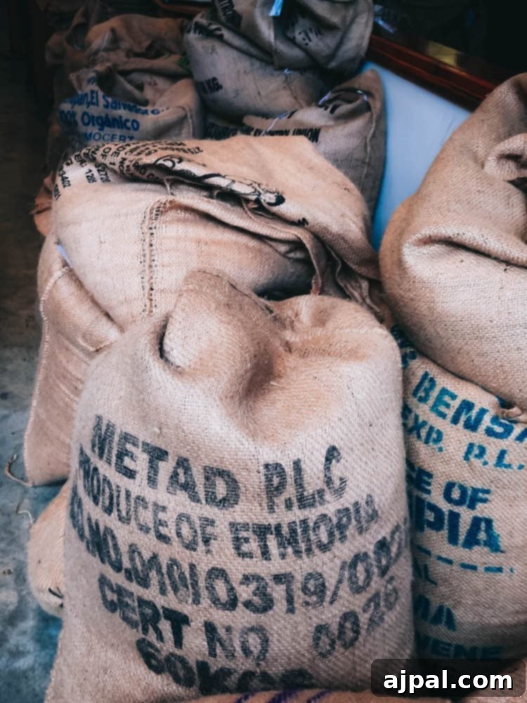 A group of sacks of coffee sitting on a floor, emphasizing the keyword “what to eat in Atascadero.