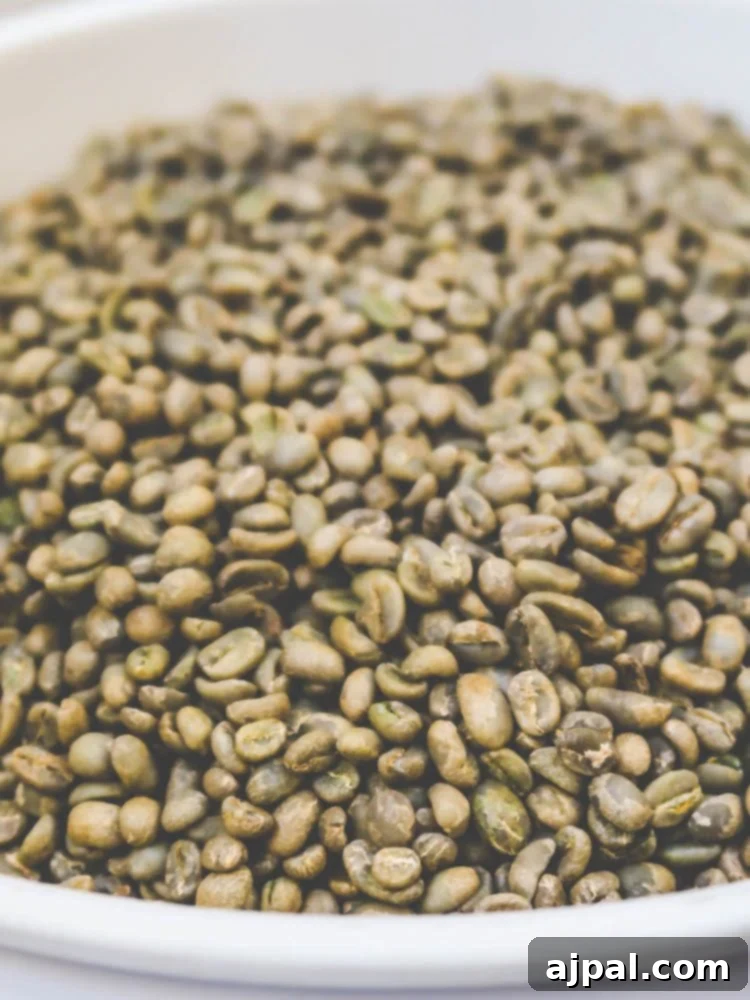 Aesthetic display of green coffee beans in a bowl on a table.