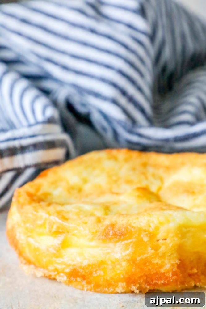 A golden-brown keto bread slice, perfectly baked with a soft interior, resting on a baking sheet, ready to be enjoyed.