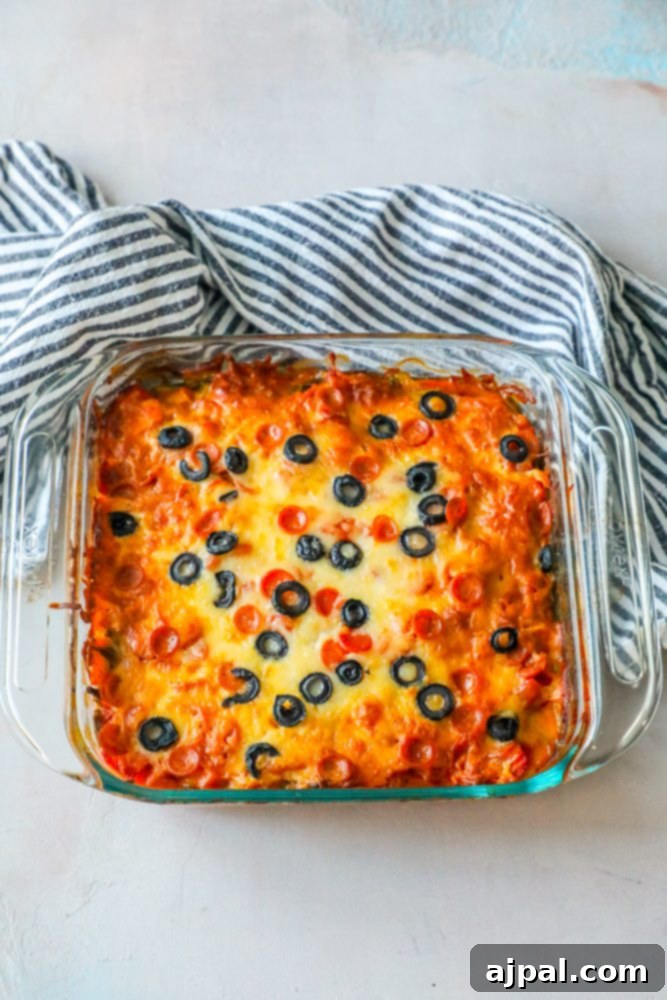 Ultimate Pizza Bake 3 Close-up of baked cheesy keto pizza casserole topped with black olives.