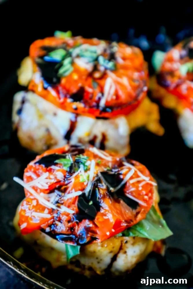 Juicy Caprese chicken thighs, adorned with basil and mozzarella, in an oven-safe pan, ready for serving.