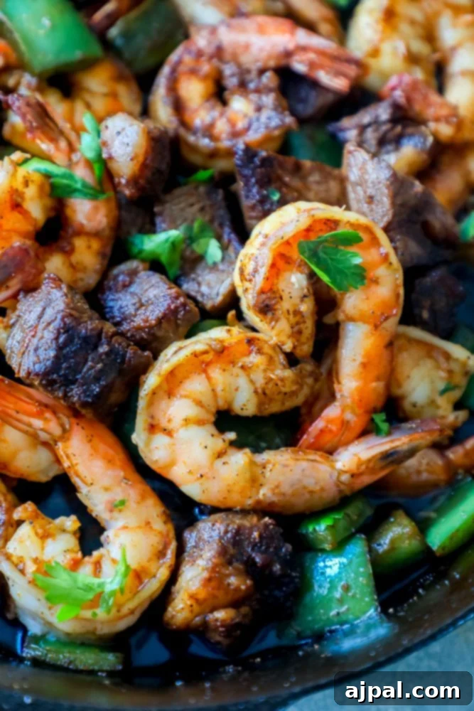 Decadent Cajun Butter Steak and Shrimp 7 Shrimp and steak cooked in a skillet with Cajun butter, presented beautifully.