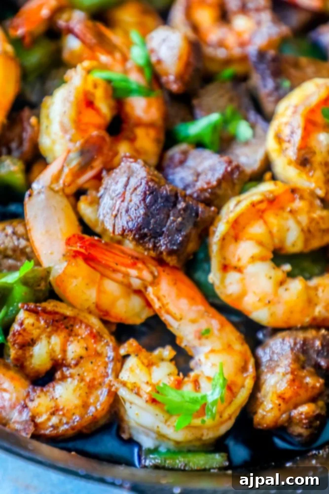Decadent Cajun Butter Steak and Shrimp 3 Cajun Butter Steak Bites with Shrimp in a skillet, showcasing the rich sauce and tender ingredients.