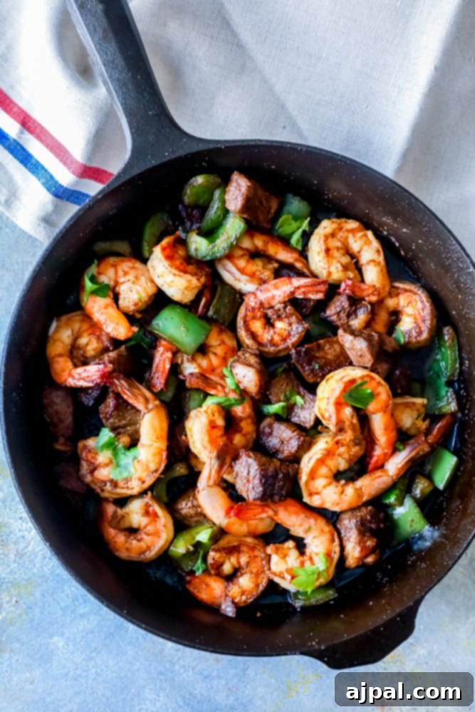 Close-up of Cajun steak and shrimp skillet, freshly cooked and ready to serve.
