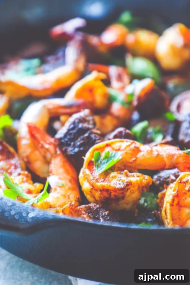 Decadent Cajun Butter Steak and Shrimp 5 A skillet full of Cajun shrimp and steak bites with vibrant peppers, ready to be served.