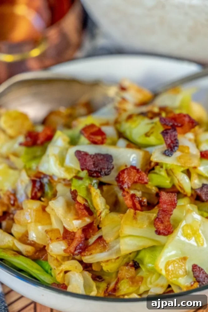 Sautéed cabbage and bacon in a white bowl, ready to serve.
