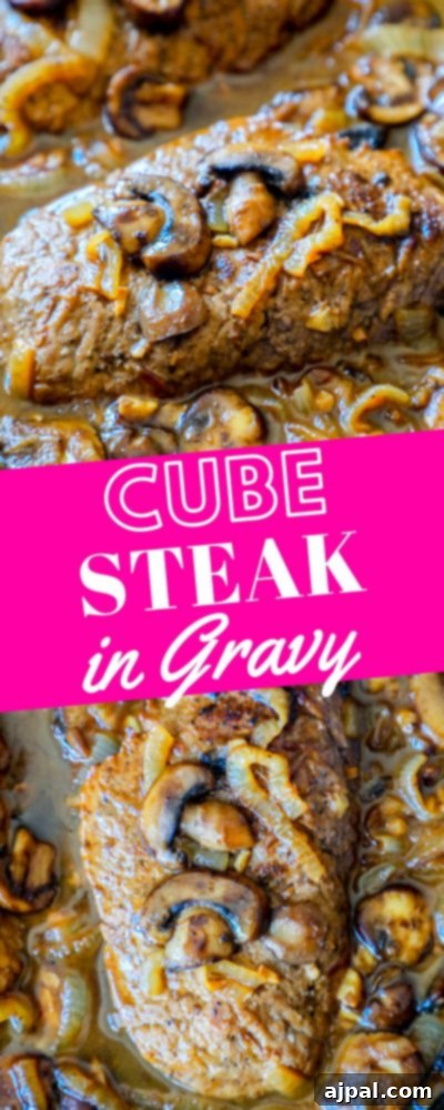 Tender Cube Steak Smothered in Savory Gravy 7 A stunning vertical close-up of tender cube steak covered in a rich mushroom and onion gravy, perfect for pinning on Pinterest.