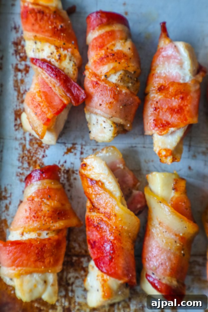 Bacon wrapped chicken bites on a baking sheet.
